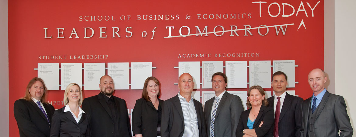 EMTM class in front of 'leaders of today' sign